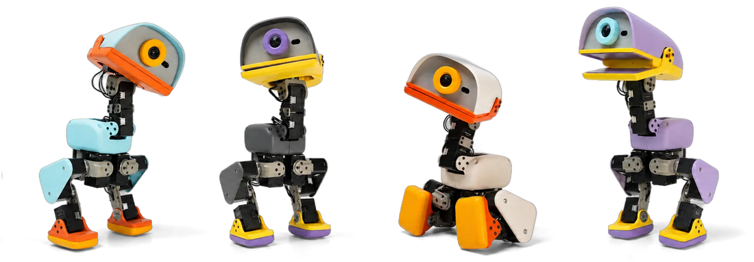 Four Microduck biped robots in Cream, Graphite, Lavender, and Sky colourways